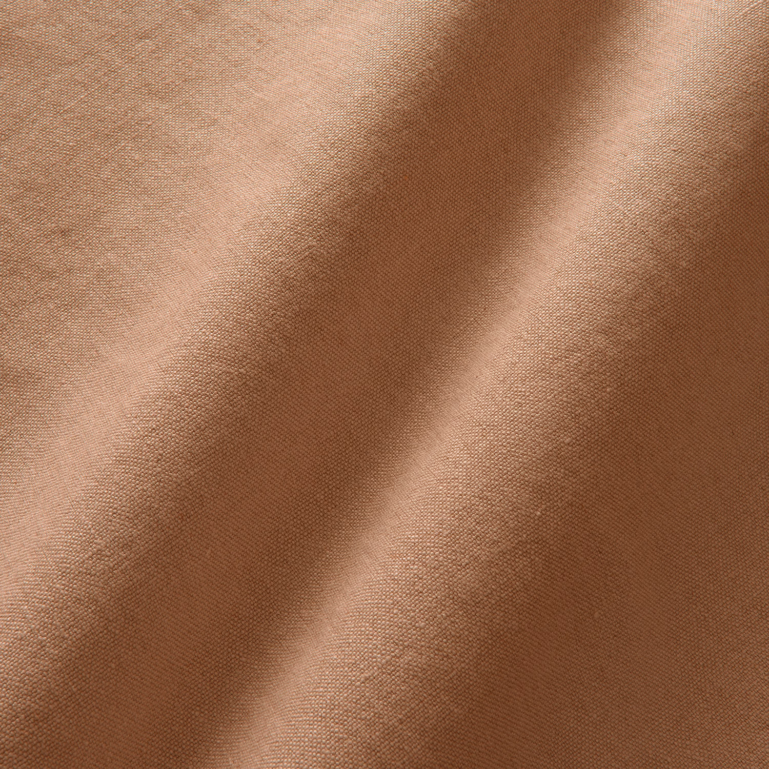 Warm terracotta linen with a fine plain weave falling into soft folds