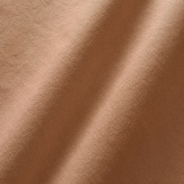 Warm terracotta linen with a fine plain weave falling into soft folds