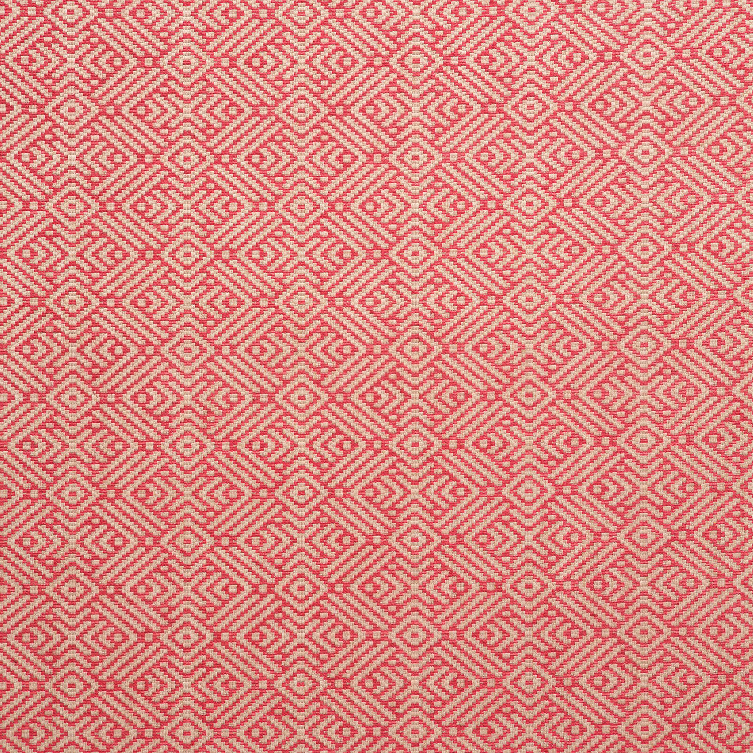 Pink-coral woven fabric with cream diamond and zigzag motifs in close repeat