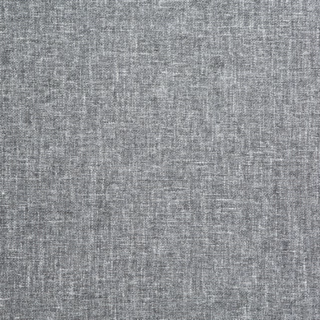 Close-up of cool slate-grey fabric with a fine pale and dark woven texture
