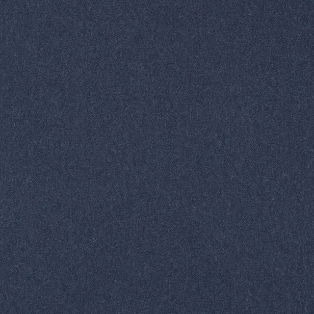 Close-up of deep denim blue plain woven fabric with subtle charcoal mottling