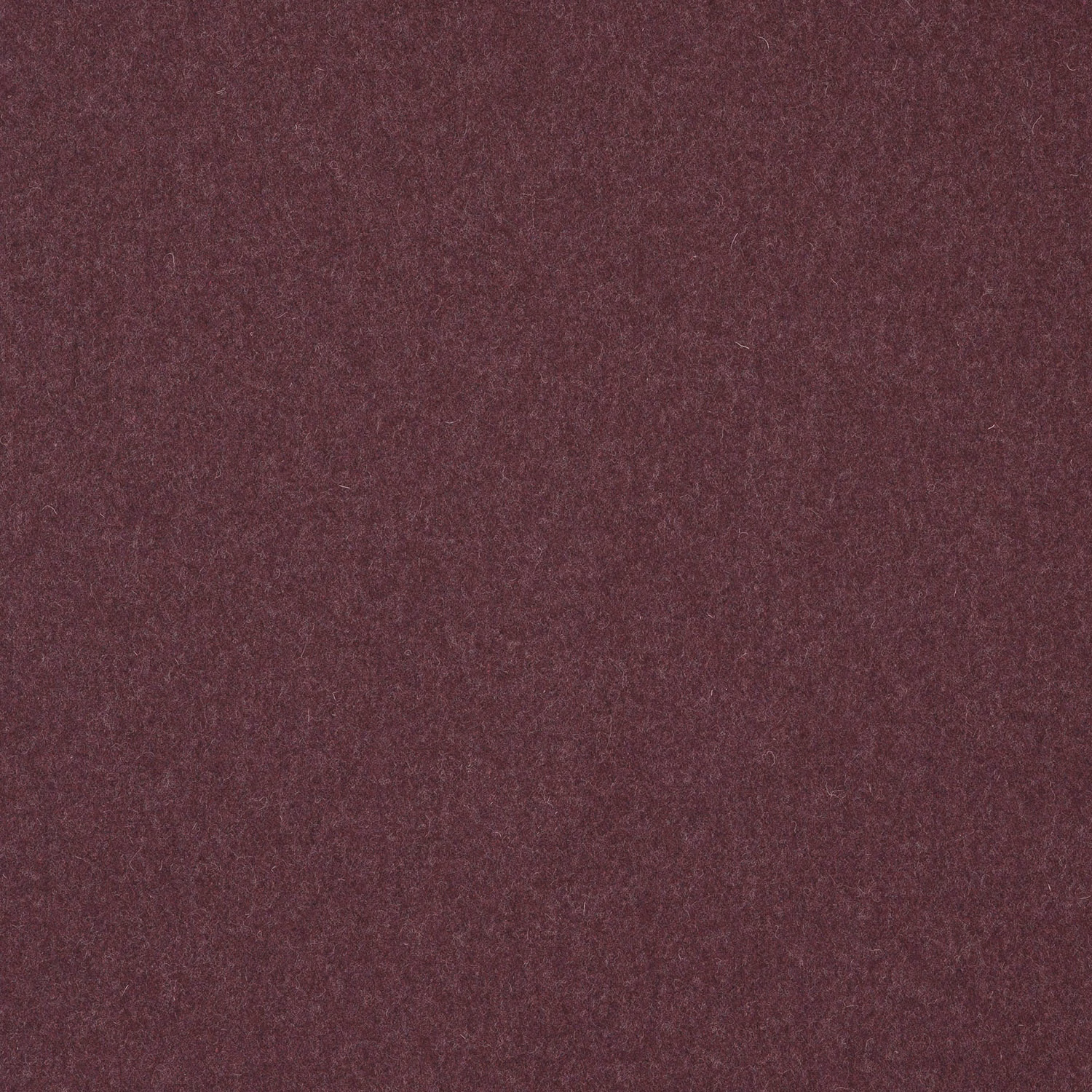 Close-up of deep muted plum wool-blend fabric with a softly mottled plain weave