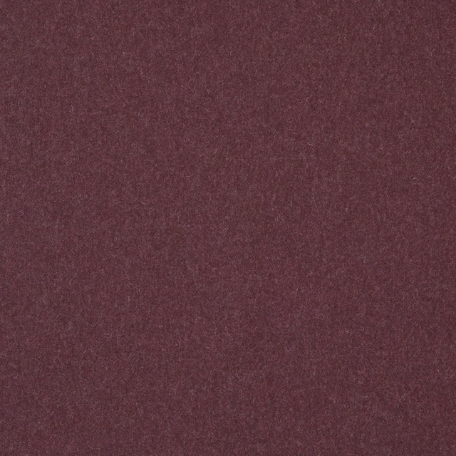 Close-up of deep muted plum wool-blend fabric with a softly mottled plain weave