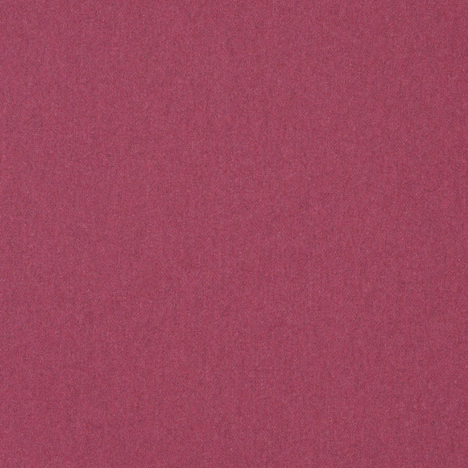 Close-up of deep raspberry pink plain woven fabric with subtle tonal texture