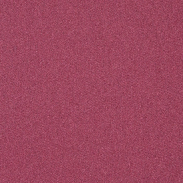 Close-up of deep raspberry pink plain woven fabric with subtle tonal texture