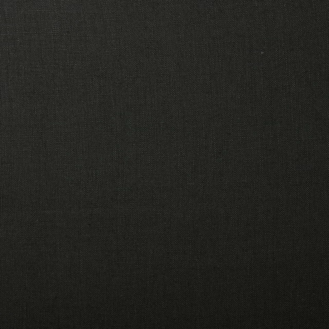 Close-up of deep charcoal-black plain linen showing a fine, subtly irregular weave