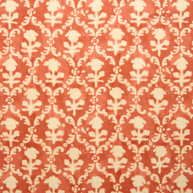 Coral-red linen swatch with cream damask-style repeat pattern