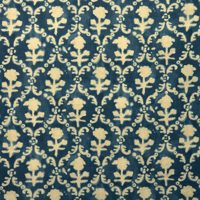 Indigo blue linen fabric with pale cream floral lattice pattern