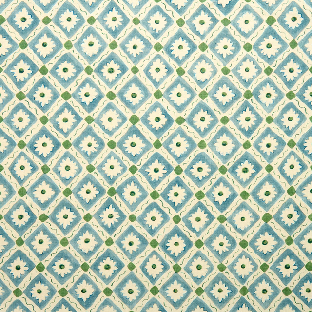 Marine blue diamond lattice linen fabric with cream flower motifs and green accents