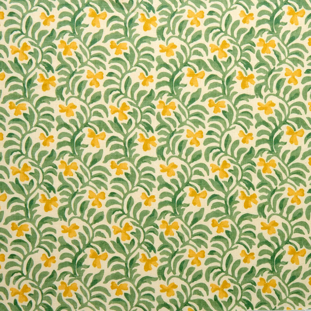 Green leafy botanical print with small saffron-yellow flowers on a warm cream ground