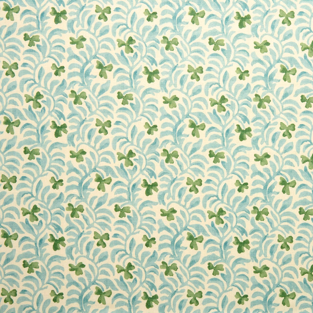 Aqua teal botanical print with small green leaf motifs on a cream ground