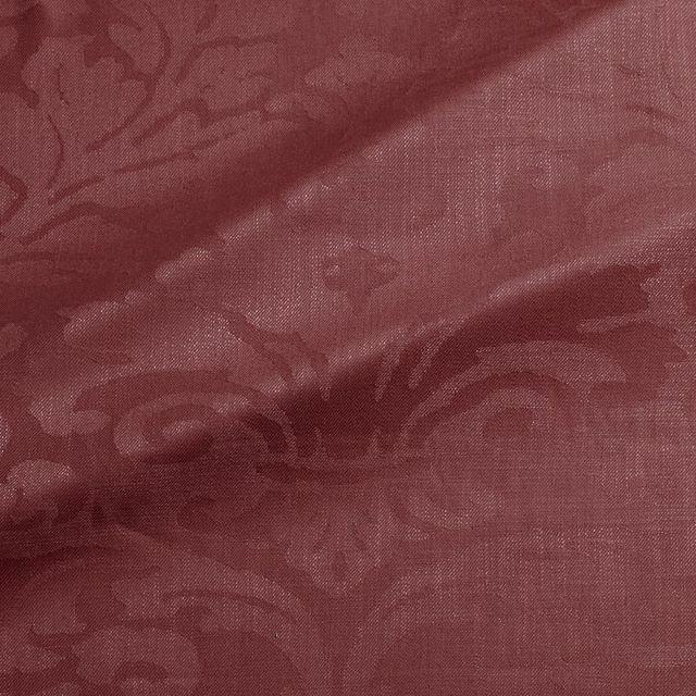 Muted damson damask with tonal scrolling motifs and a fine woven texture