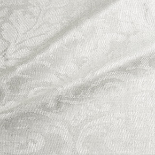 Eggshell damask weave with soft ivory scrolls and subtle raised texture
