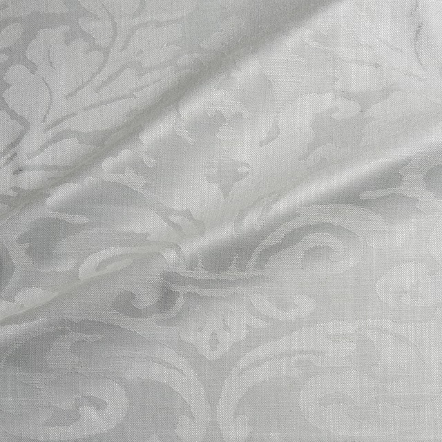 Pale silver-grey woven damask with soft ivory scrolling floral motifs