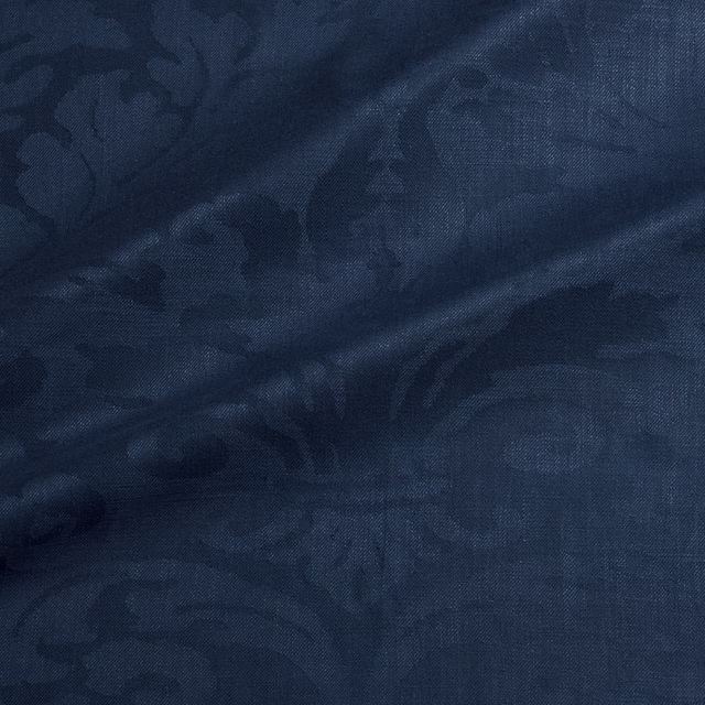 Dark ocean-blue damask with shadowed floral forms and fine woven texture