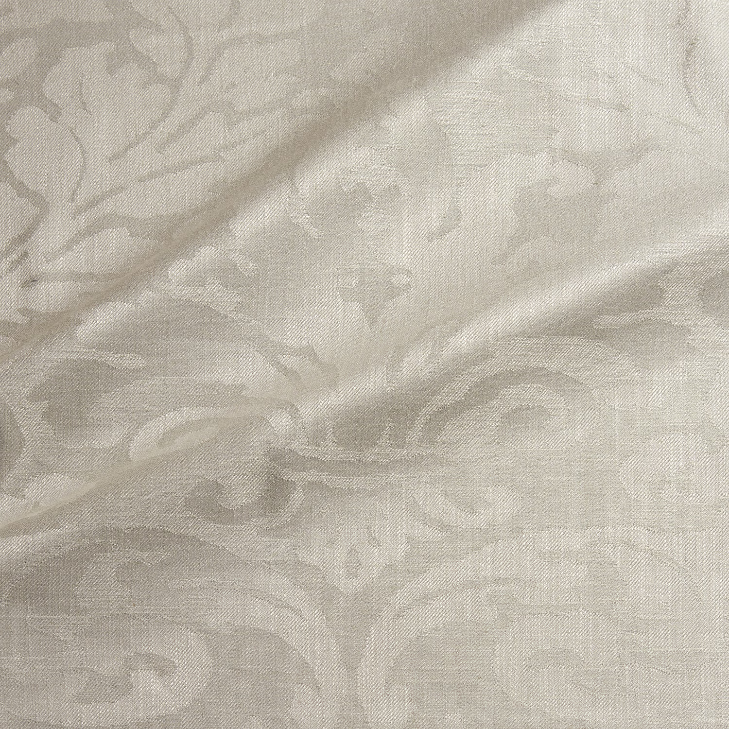 Pale almond damask with low-contrast scrolling motifs and a fine woven surface