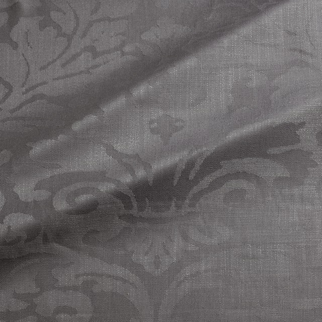 Muted pebble-grey damask fabric with charcoal scrolling motifs and fine woven texture
