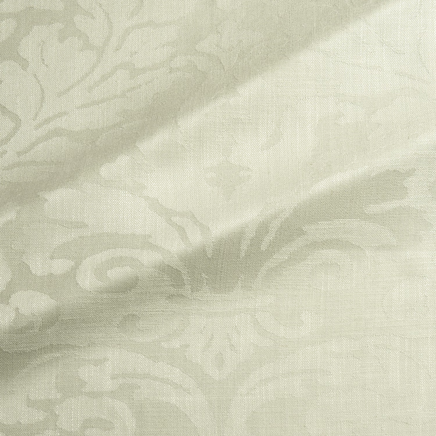 Pale pistachio-green woven damask with softly raised scrolling motifs and visible fine texture