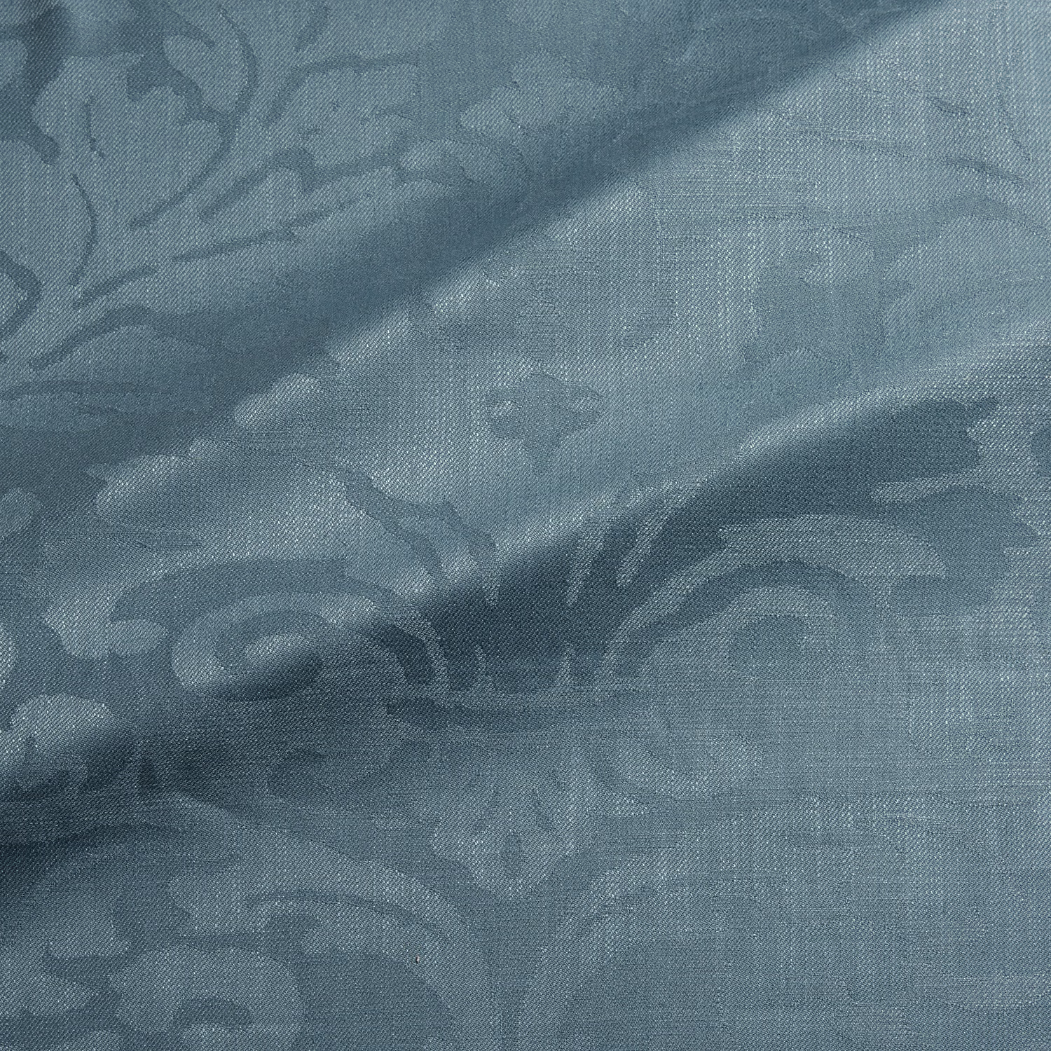 Muted blue-teal woven damask with large scrolling motifs and fine textured ground