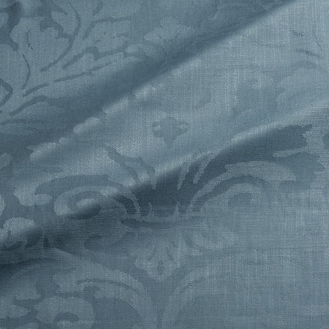 Muted blue-teal woven damask with large scrolling motifs and fine textured ground