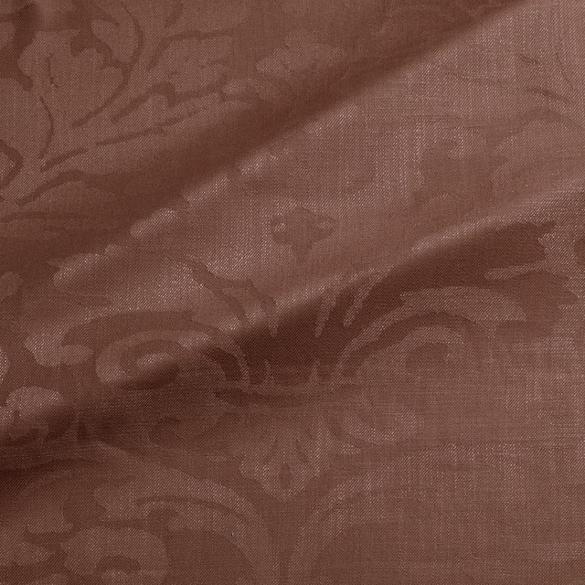 Muted rosewood-brown woven damask with scrolling floral motifs and tactile texture