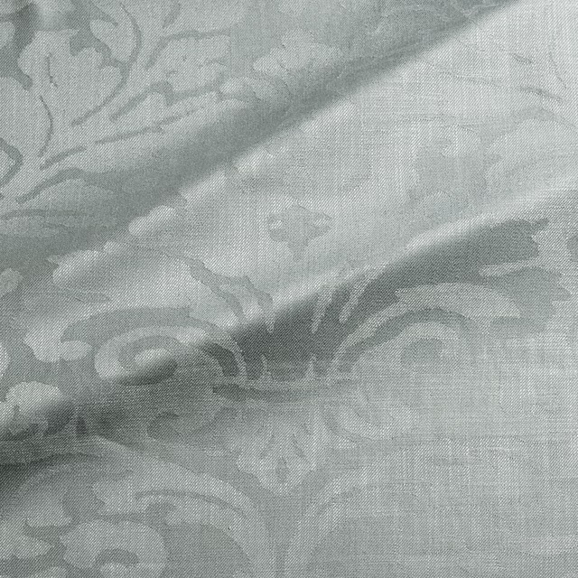Pale sea-mist blue-grey woven damask with scrolling floral motifs and fine texture