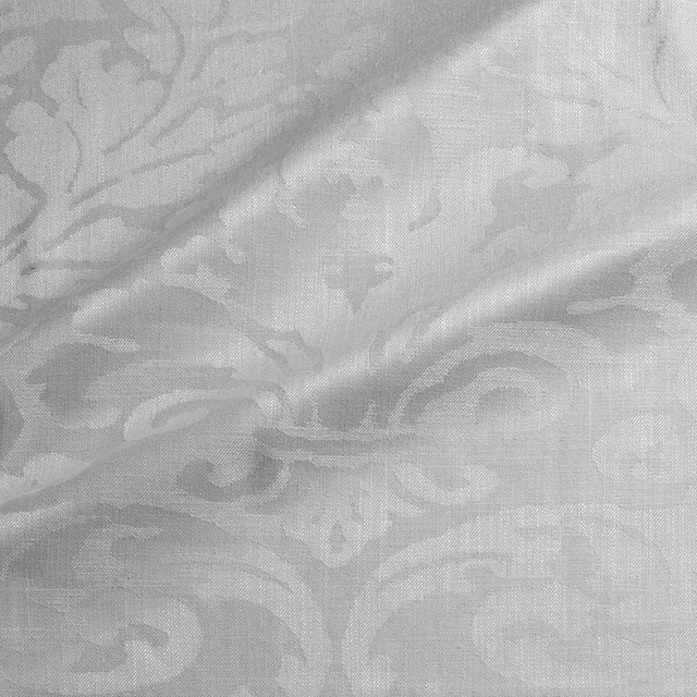 Pale silver-grey woven damask with soft scrolling motifs and fine crosshatch texture