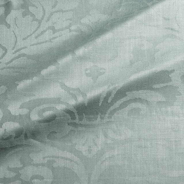 Pale aqua-teal damask weave with sweeping scrolls and a softly crosshatched surface