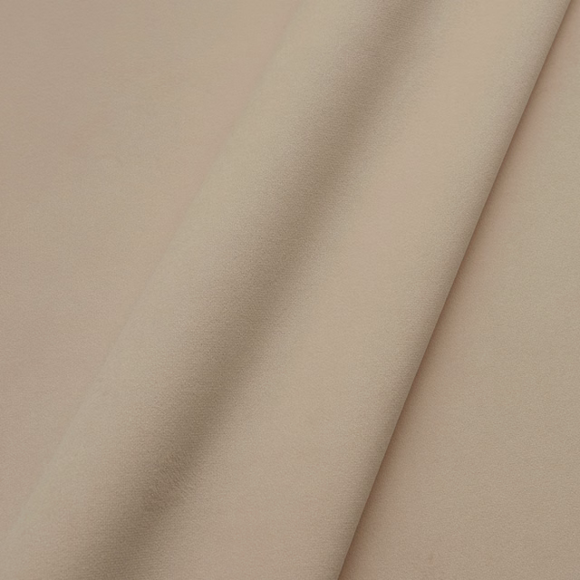 Warm biscuit-beige velvet with a softly brushed nap folded into gentle shadows
