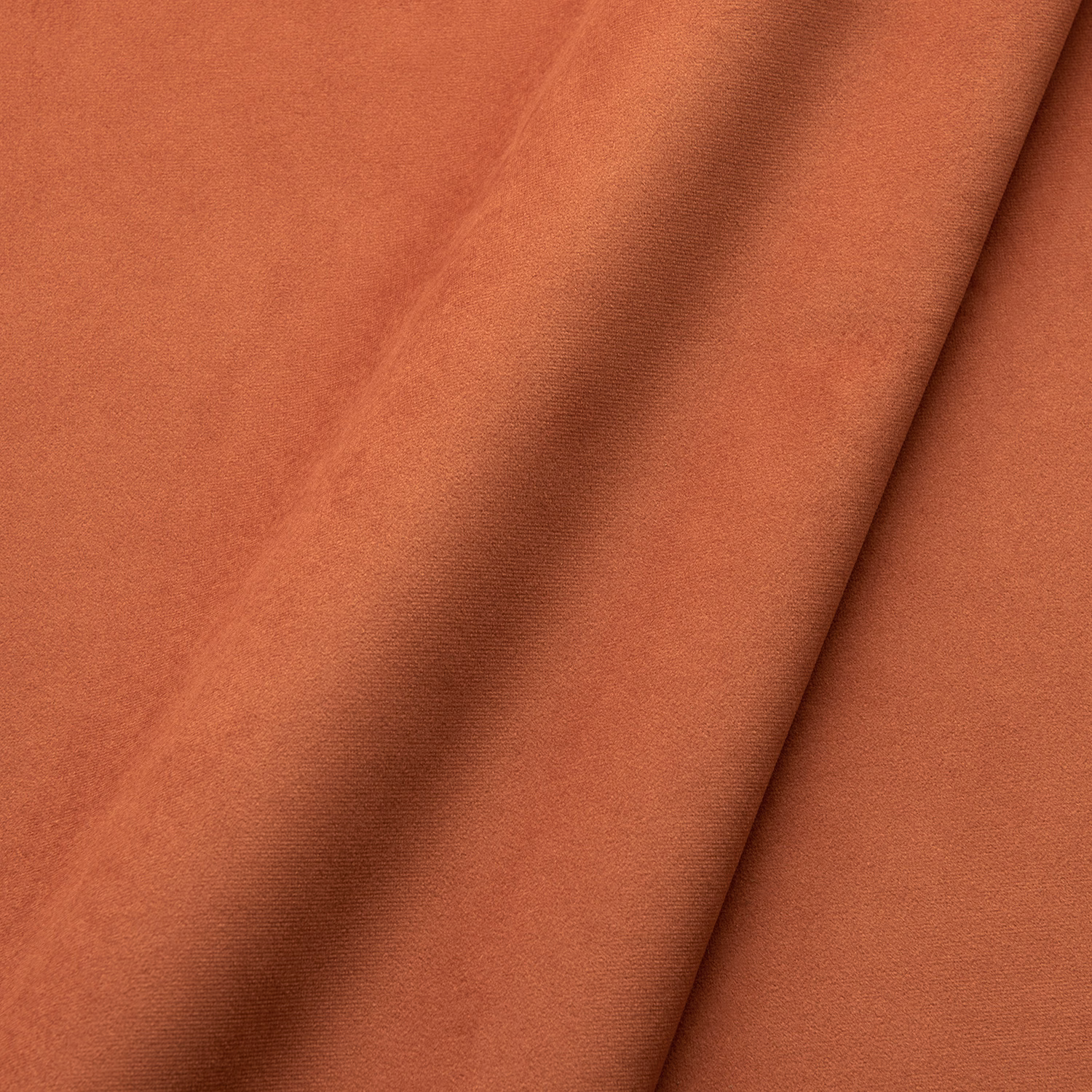 Warm henna terracotta velvet showing soft nap, tonal shading and folded sheen
