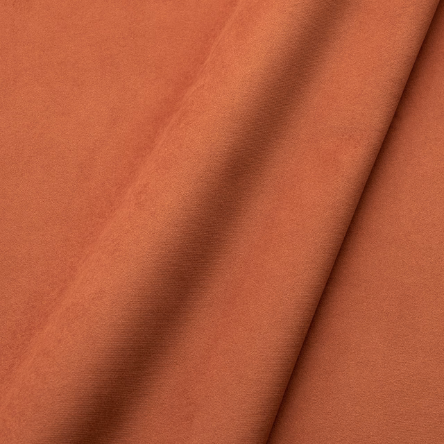 Warm henna terracotta velvet showing soft nap, tonal shading and folded sheen