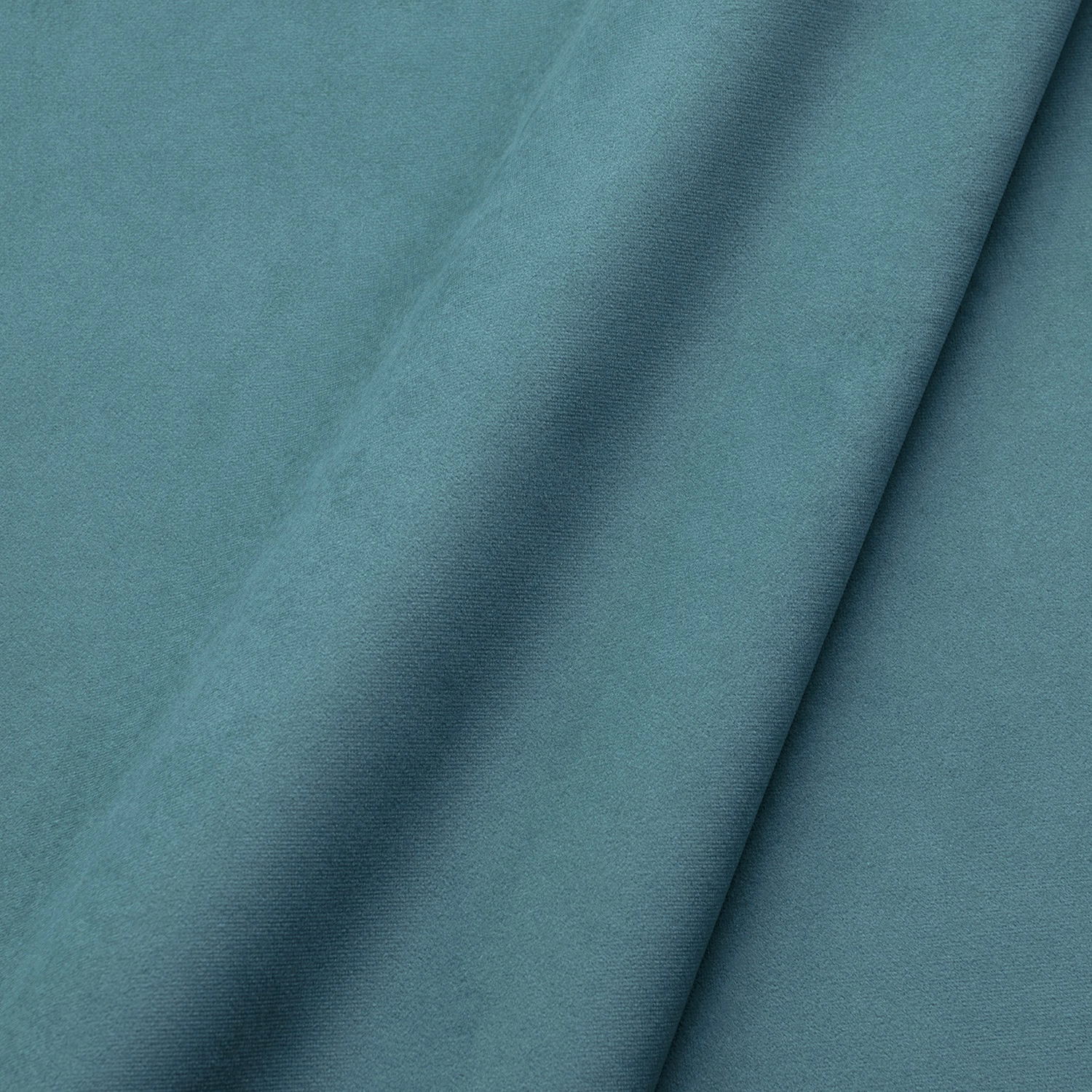 Close-up of plain lagoon teal velvet with soft nap and darker folded shading
