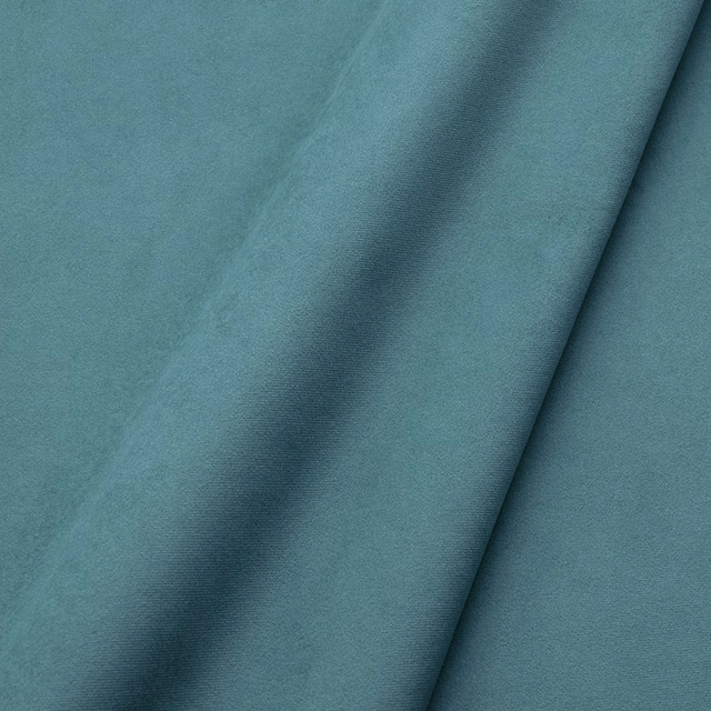 Close-up of plain lagoon teal velvet with soft nap and darker folded shading
