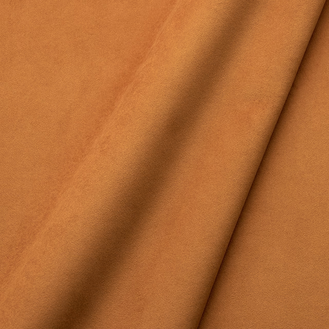 Warm turmeric-orange velvet with a close pile and darker fold shading