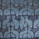 Dusty blue stylised elephants arranged on a textured deep navy patterned fabric