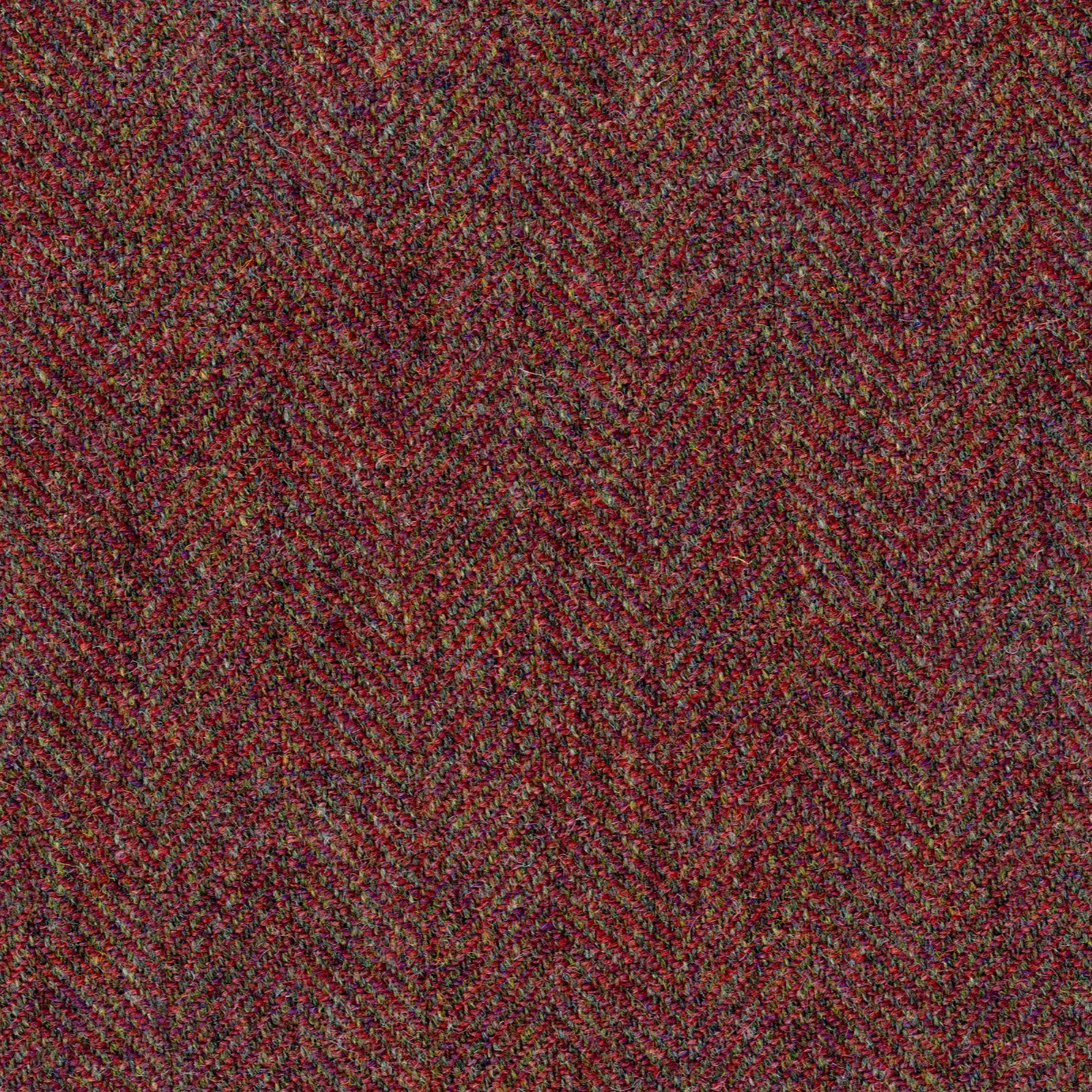 Close-up of deep berry-red herringbone weave with charcoal and olive flecks