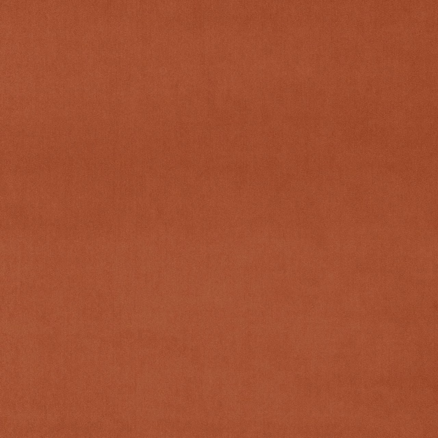 Rust terracotta velvet fabric with a smooth plain pile and soft sheen