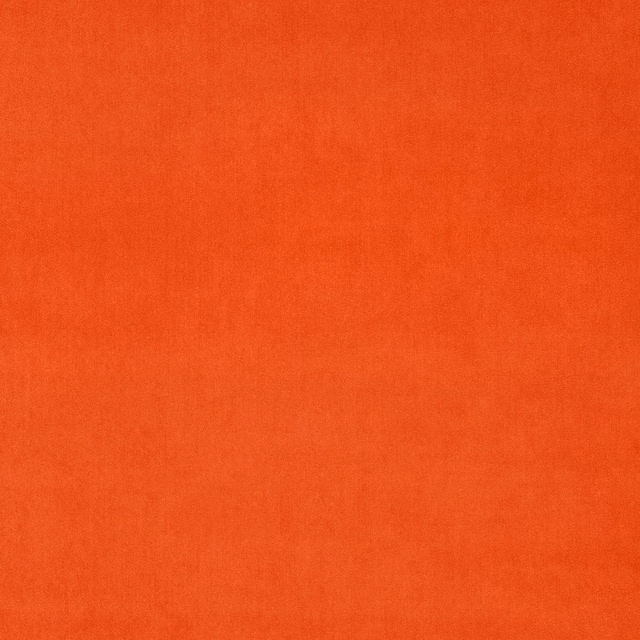 Close-up of vivid orange plain velvet with a soft, dense pile