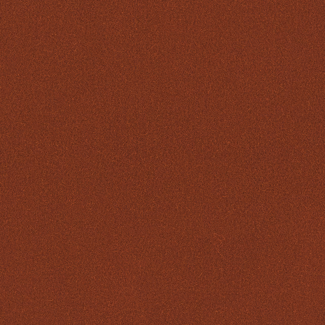 Close-up of muted brick-red Romney wool with a fine, even woven texture