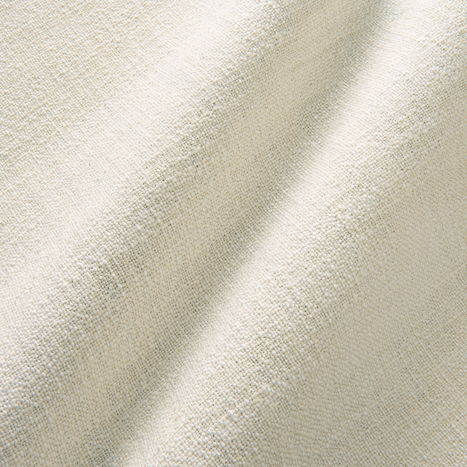 Ivory cream plain woven fabric with subtle nubby texture and soft folded shadows