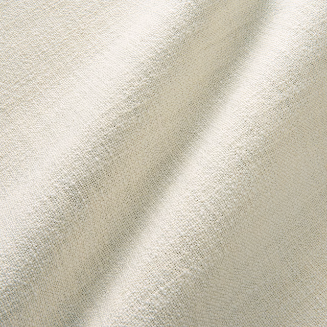 Ivory cream plain woven fabric with subtle nubby texture and soft folded shadows