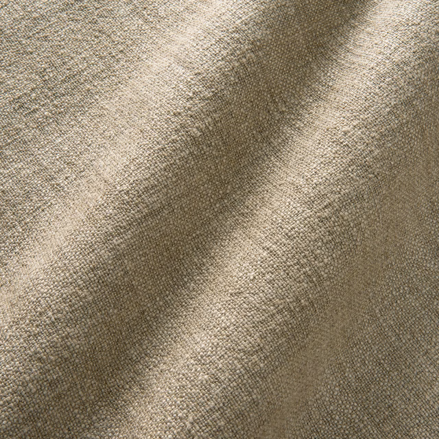 Warm latte-taupe plain weave with fine pebbled linen texture in diagonal folds