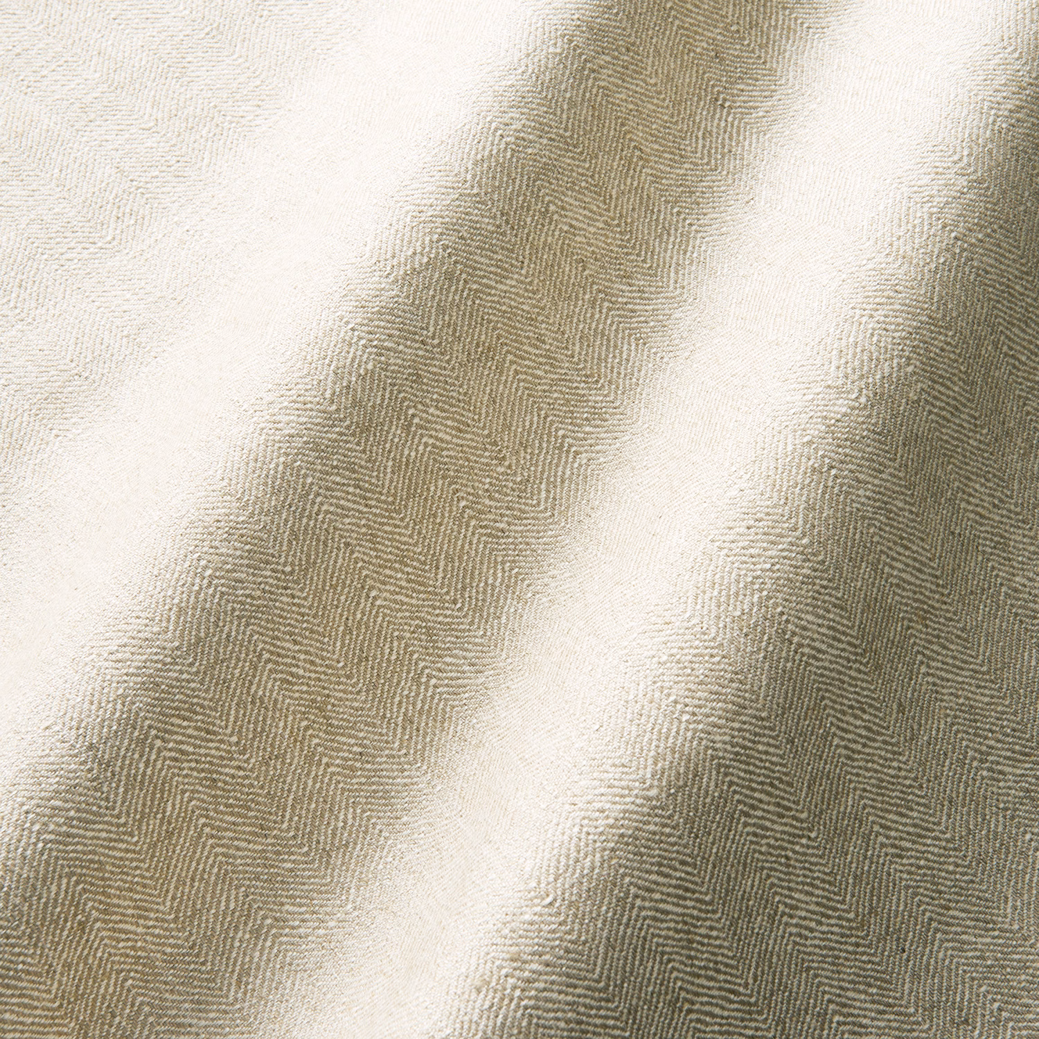 Warm biscuit-beige herringbone fabric draped in softly shadowed folds