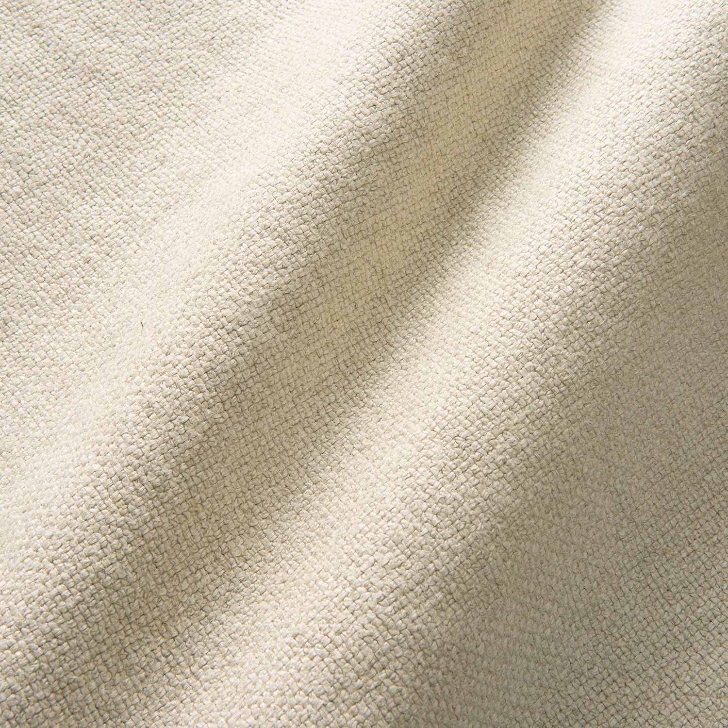 Warm ivory pumice fabric showing a fine nubby weave across softly folded cloth