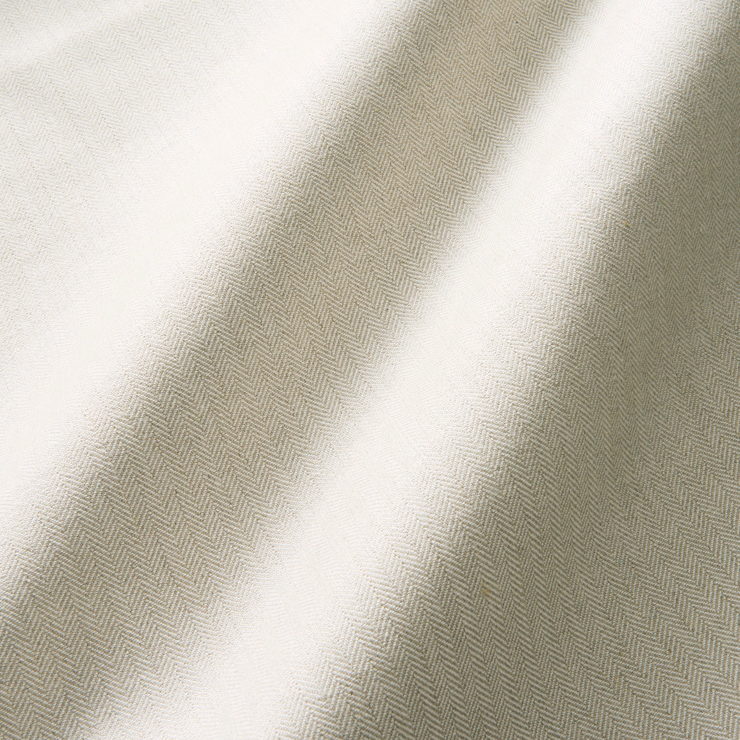 Pale rattan cream fabric with fine herringbone weave and softly folded texture