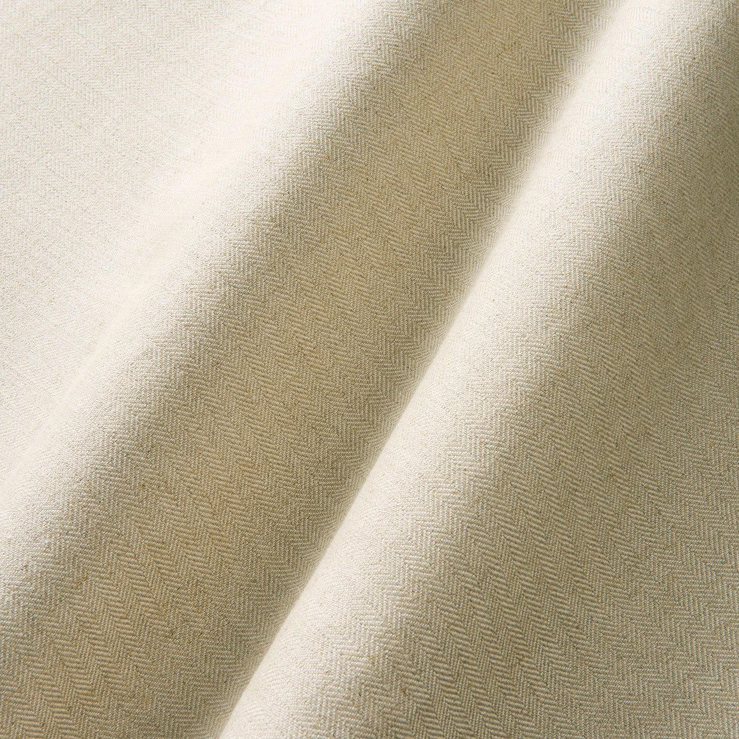 Warm sand herringbone weave with pale cream highlights across folded fabric