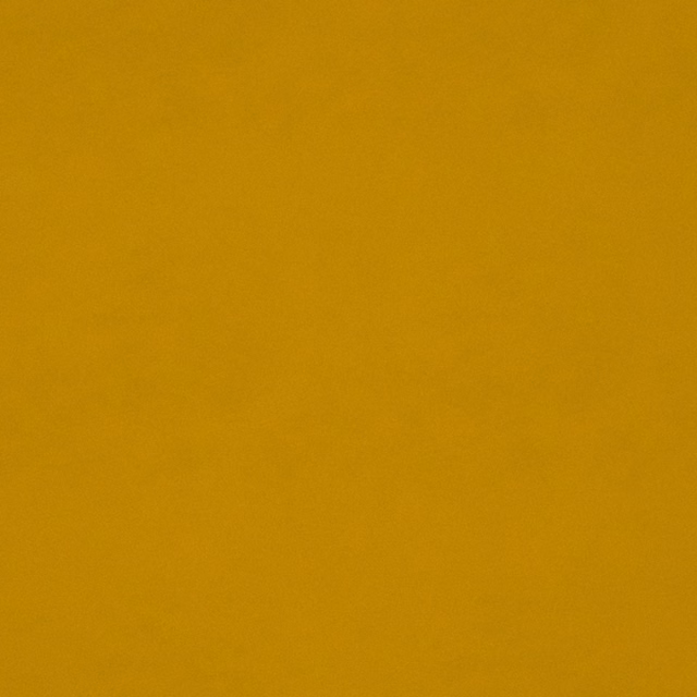 Close-up of plain ochre-gold velvet showing a soft, subtly shaded pile