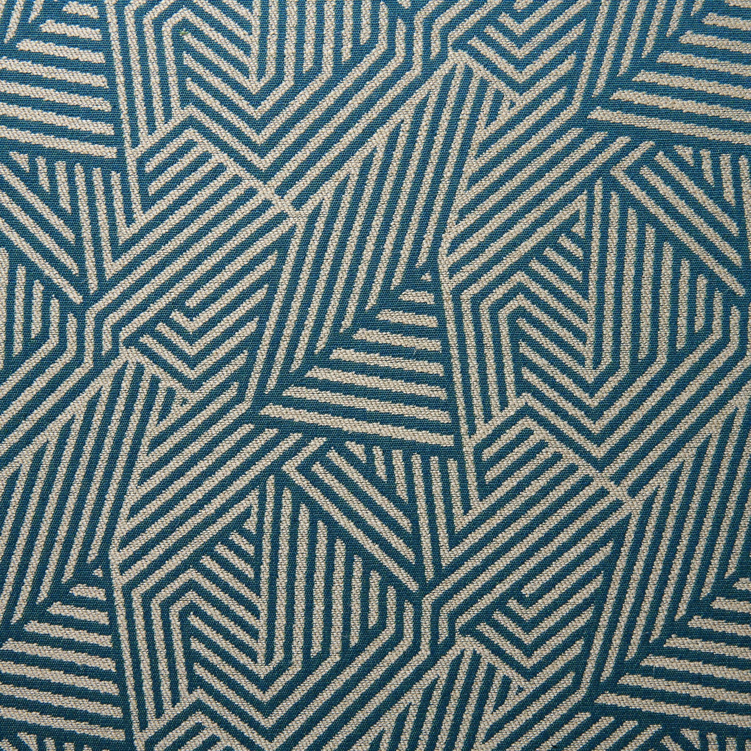 Blue-teal woven fabric with cream interlocking chevrons and angular stripes