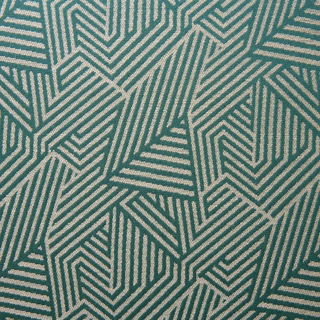 Close-up of muted teal woven fabric with pale interlocking geometric chevrons