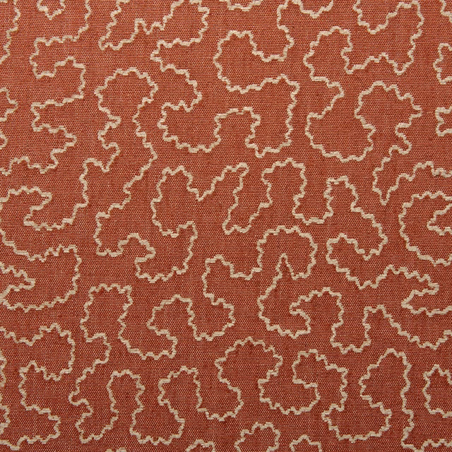 Carmine red woven fabric with small cream-edged irregular abstract motifs